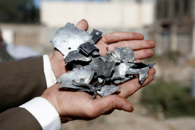 sanaa-yemen-20th-apr-2025-a-man-shows-fragments-of-a-missile-at-a-public-cemetery-following-u-s-airstrikes-in-sanaa-yemen-on-april-20-2025-at-least-three-people-were-killed-and-four-others-wo