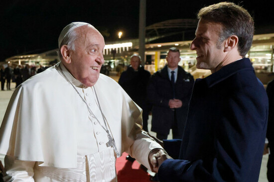 pope-francis-shakes-hands-with-frances-president-emmanuel-macron-right-arrive-after-their-meeting-for-the-popes-departure-ceremony-at-the-ajaccio-airport-on-the-french-island-of-corsica-sunday-d
