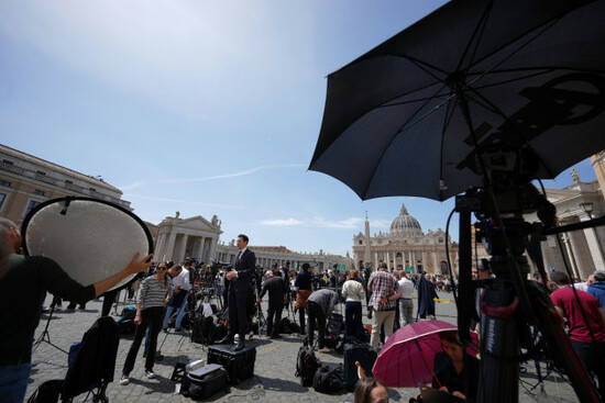 reporters-and-media-staffers-gather-in-st-peters-square-at-the-vatican-after-cardinal-camerlengo-kevin-joseph-farrell-announced-the-death-of-pope-francis-monday-april-21-2025-ap-photoandrew-me