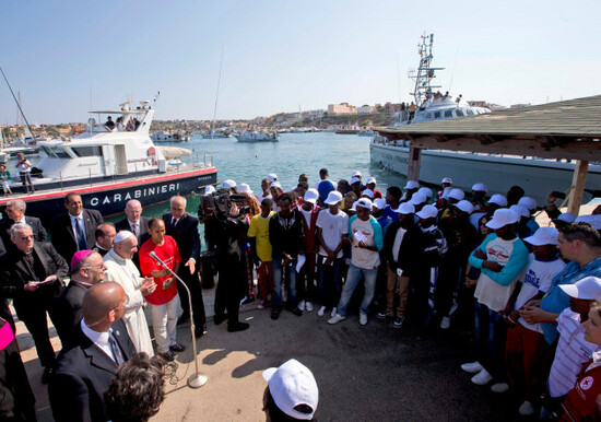file-pope-francis-left-speaks-to-migrants-wearing-white-caps-during-his-visit-to-the-island-of-lampedusa-southern-italy-monday-july-8-2013-ap-photoalessandra-tarantino-pool