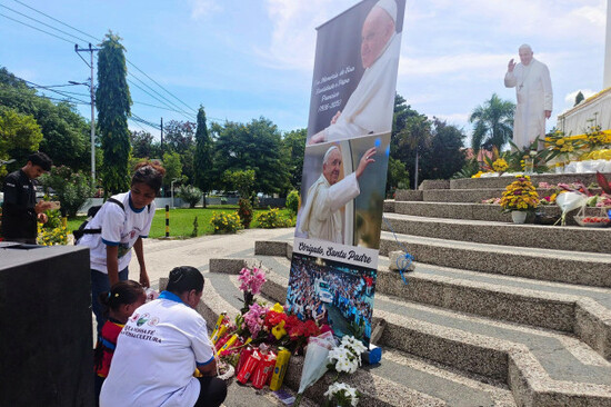 devotees-lay-flowers-in-front-of-a-banner-of-the-late-pope-francis-during-a-prayer-in-dili-east-timor-tuesday-april-22-2025-ap-photosuzana-cardoso
