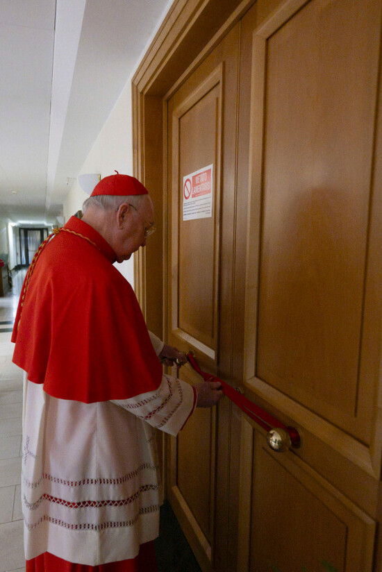 this-image-distributed-by-vatican-media-on-tuesday-april-22-2025-shows-cardinal-camerlengo-kevin-joseph-farrell-sealing-pope-franciss-private-apartment-inside-the-domus-sanctae-marthae-hotel-at