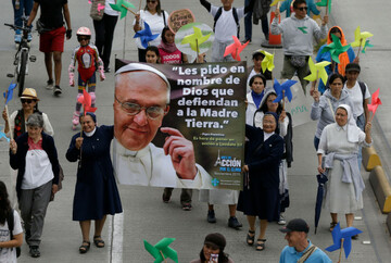 nuns-holds-a-banner-with-a-image-of-pope-francis-that-reads-in-spanish-i-ask-you-in-the-name-of-god-to-defend-mother-earth-during-a-silent-march-calling-for-ambitious-action-to-tackle-climate-chang