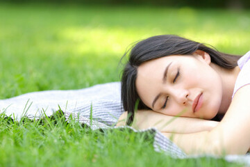 asian-woman-sleeping-lying-on-the-grass-in-a-park