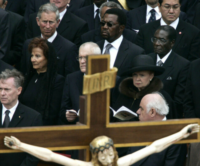file-in-this-friday-april-8-2005-file-photo-britains-prince-charles-rear-left-and-zimbabwes-president-robert-mugabe-center-right-attend-the-funeral-of-pope-john-paul-ii-in-the-center-of-st