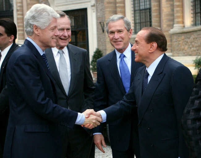 president-george-w-bush-and-his-father-former-president-george-bush-look-on-as-italian-prime-minister-silvio-berlusconi-and-former-president-bill-clinton-shake-hands-thursday-april-7-2005-prior