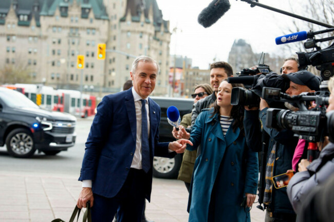 canadian-prime-minister-mark-carney-passes-journalists-as-he-arrives-at-the-office-of-the-prime-minister-and-privy-council-the-morning-after-the-liberal-party-won-the-canadian-federal-election-in-ot