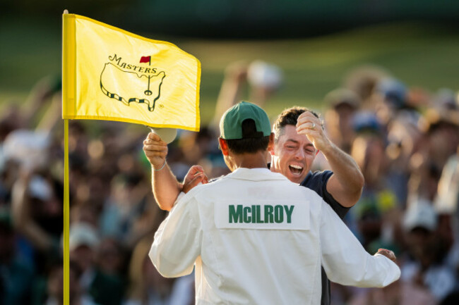 rory-mcilroy-of-northern-ireland-celebrate-on-the-18th-green-with-his-caddie-harry-diamond-after-his-final-putt-in-the-playoff-to-win-the-final-round-of-the-2025-masters-golf-tournament-on-april