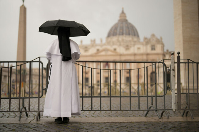a-nun-shelters-from-the-rain-as-she-follows-a-final-mass-celebrated-by-cardinals-inside-st-peters-basilica-before-the-conclave-to-elect-a-new-pope-in-st-peters-square-at-the-vatican-wednesday