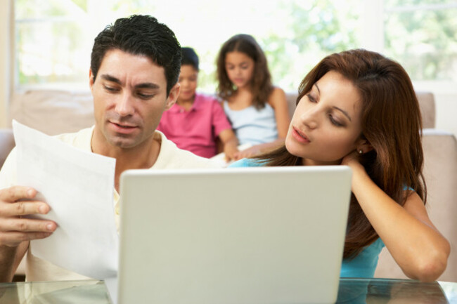 worried-parents-using-laptop-at-home