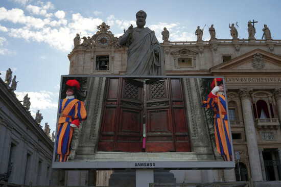 a-giant-screen-in-st-peters-basilica-shows-a-vatican-official-closing-the-door-to-the-sistine-chapel-after-calling-out-extra-omnes-latin-for-all-out-during-the-cardinals-conclave-to-elect-a-ne