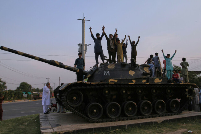 pakistanis-flash-victory-signs-as-they-celebrate-on-top-of-a-model-of-a-tank-following-india-and-pakistan-have-reached-a-ceasefire-deal-during-a-demonstration-in-multan-pakistan-saturday-may-10