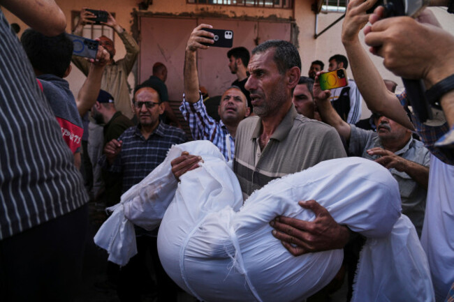 mohammad-nassar-carries-the-body-of-his-nephew-jana-nassar-killed-in-an-israeli-army-airstrike-on-the-gaza-strip-during-his-funeral-at-al-aqsa-hospital-in-deir-al-balah-gaza-tuesday-may-20-2025
