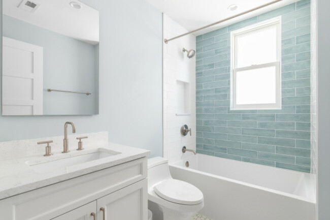 abathroomwithawhitevanitycabinetwhitemarblecountertop