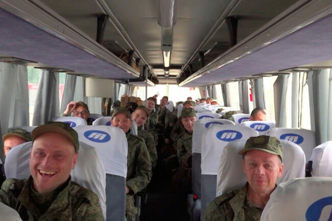 in-this-photo-taken-from-a-video-released-by-russian-defense-ministry-press-service-russian-servicemen-ride-a-bus-after-returning-from-captivity-following-an-exchange-between-russia-and-ukraine-at-a