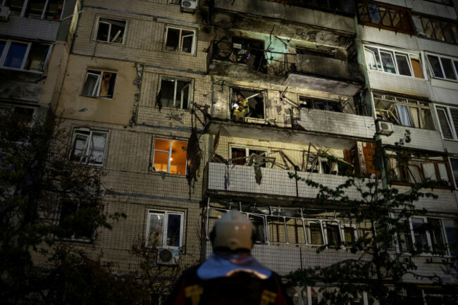 emergency-workers-navigates-his-colleagues-at-the-site-of-residential-building-damaged-after-a-russian-attack-in-kyiv-ukraine-saturday-may-24-2025-ap-photoalex-babenko