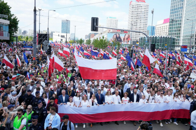 the-liberal-presidential-candidate-rafal-trzaskowski-holds-a-giant-polish-flag-in-the-first-row-as-he-stands-next-to-a-waving-women-during-a-march-one-week-ahead-of-a-decisive-presidential-election-in