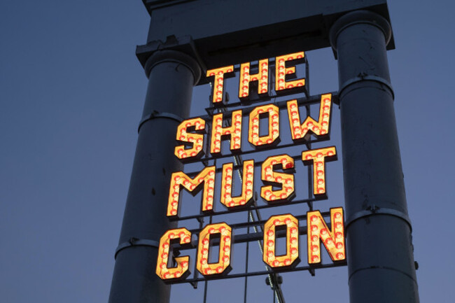 neon-sign-the-show-must-go-on-installed-by-the-stove-network-over-the-dumfries-suspension-bridge-inspired-by-the-historic-rood-fair