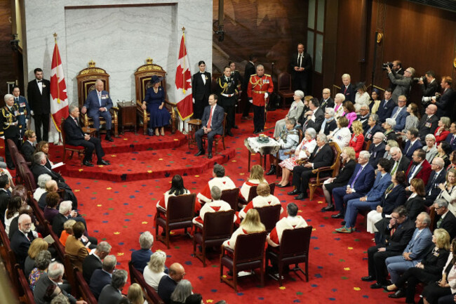 king-charles-iii-and-queen-camilla-sit-in-the-thrones-beside-prime-minister-of-canada-mark-carney-front-of-steps-left-and-senator-marc-gold-front-right-government-representative-in-the-senate
