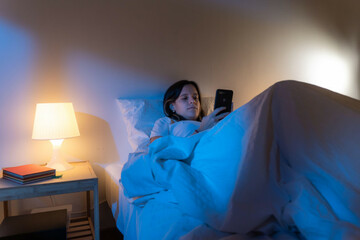 girl-looking-her-smart-phone-doom-scrolling-on-bed-in-the-middle-of-the-night-technology-at-bed-concept