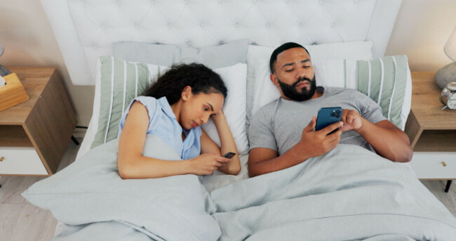 couple-smartphone-and-conflict-in-bed-ignore-and-annoyed-with-reading-chat-or-social-media-addiction-in-home-man-woman-and-doom-scrolling-with