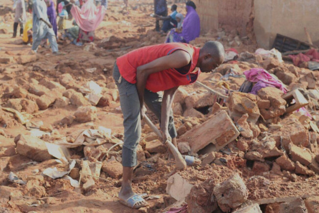 a-man-searches-the-rubble-in-a-flooded-area-after-heavy-rainfall-in-the-market-town-of-mokwa-north-central-nigeria-saturday-may-31-2025-ap-photousman-salihu-mokwa