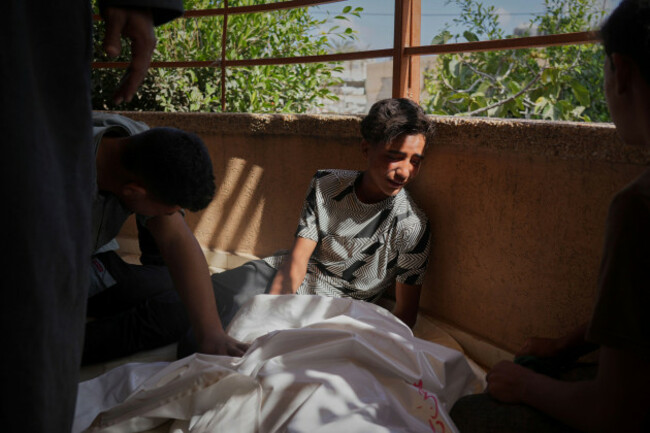 palestinians-mourn-beside-the-body-of-abdul-rahman-al-qudra-who-was-killed-while-heading-to-a-gaza-aid-hub-during-his-funeral-at-the-nasser-hospital-in-khan-younis-southern-gaza-strip-tuesday-june