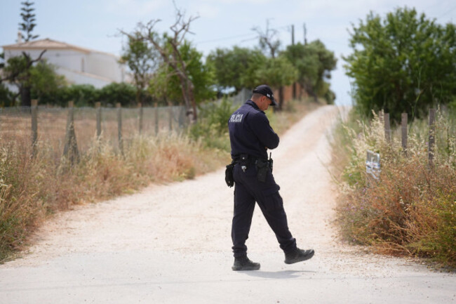 a-portuguese-police-officer-patrols-the-entrance-to-a-road-to-the-west-of-praia-de-luz-portugal-where-searches-are-being-carried-out-by-officers-investigating-the-disappearance-of-madeleine-mccann
