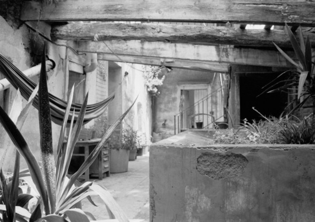 can-masdeu-barecelona-spain-2004-derelict-old-bath-house-turned-patio-area-with-hammock-swinging-from-broken-roof-beams