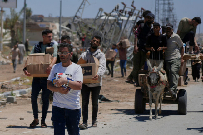 palestinians-carry-boxes-and-bags-containing-food-and-humanitarian-aid-packages-delivered-by-the-gaza-humanitarian-foundation-a-u-s-backed-organization-approved-by-israel-in-khan-younis-southern-g
