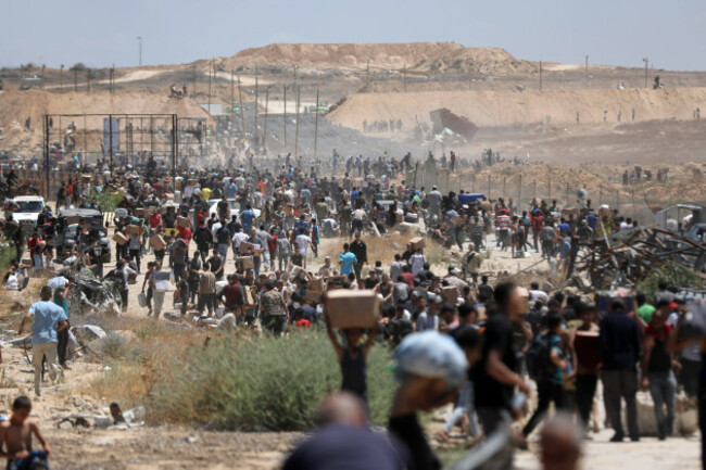 palestinians-walk-with-aid-supplies-which-they-received-from-the-u-s-backed-gaza-humanitarian-foundation-in-al-bureij-palestinians-walk-with-aid-supplies-which-they-received-from-the-u-s-backed-gaz
