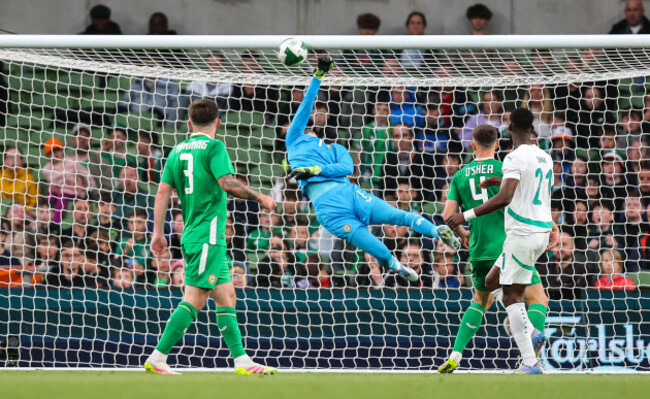 caoimhin-kelleher-makes-a-fingertip-save-from-the-header-of-abdallah-sima