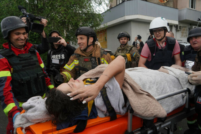 rescuers-carry-a-wounded-woman-after-russian-attack-that-hit-a-residential-building-in-kharkiv-ukraine-saturday-june-7-2025-ap-photoandrii-marienko