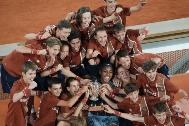 winner-coco-gauff-of-the-u-s-and-ball-boys-and-girls-pose-with-the-trophy-after-the-final-match-of-the-french-tennis-open-against-aryna-sabalenka-of-belarus-at-the-roland-garros-stadium-in-paris-sat