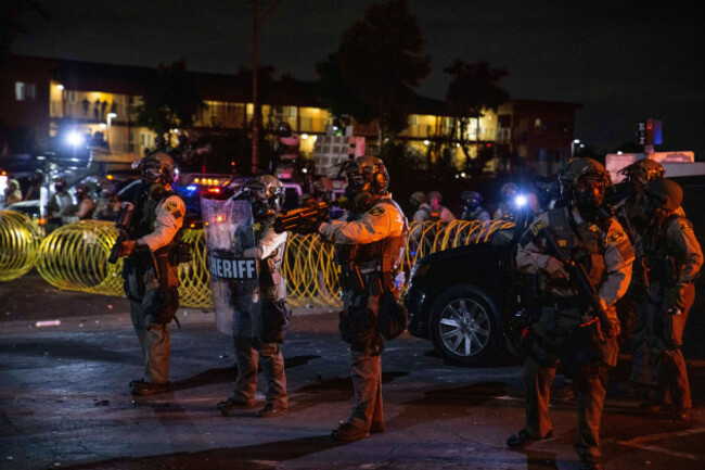 los-angeles-county-sheriffs-stand-during-a-protest-in-compton-calif-saturday-june-7-2025-after-federal-immigration-authorities-conducted-operations-ap-photoethan-swope