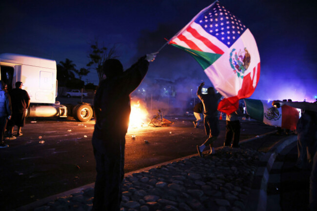 a-demonstrator-waves-an-american-and-mexican-flag-during-a-protest-in-compton-calif-saturday-june-7-2025-after-federal-immigration-authorities-conducted-operations-ap-photoethan-swope