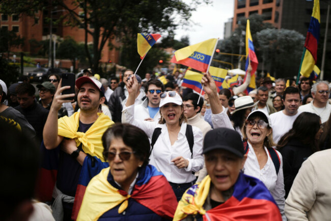 people-hold-flags-of-colombia-as-they-march-to-the-clinic-where-colombian-senator-miguel-uribe-turbay-is-being-treated-after-an-assassination-attempt-in-bogota-colombia-sunday-june-8-2025-ap-ph