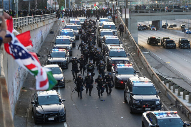 officers-make-their-way-down-a-ramp-to-the-101-freeway-near-the-metropolitan-detention-center-of-downtown-los-angeles-sunday-june-8-2025-following-last-nights-immigration-raid-protest-ap-photo