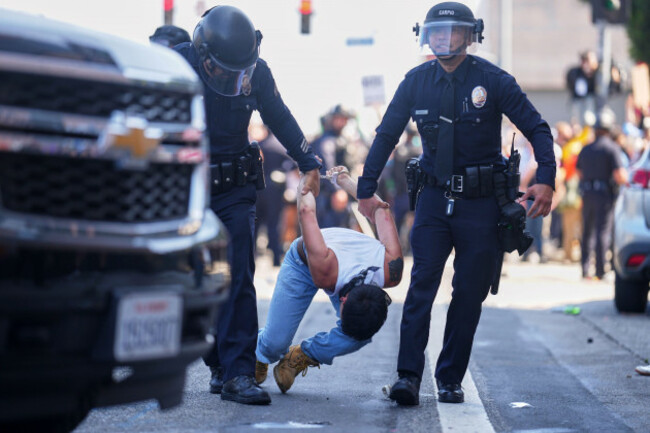 a-protestor-is-detained-in-downtown-los-angeles-sunday-june-8-2025-following-last-nights-immigration-raid-protest-ap-photoeric-thayer