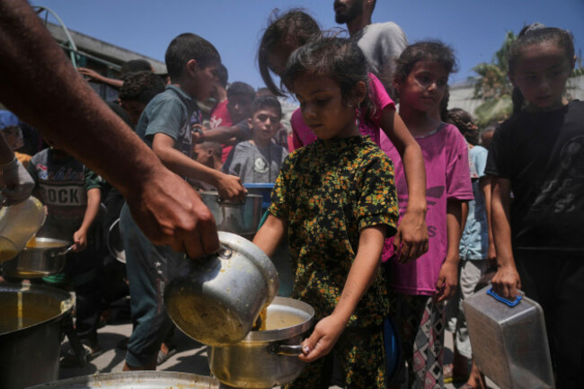 palestinians-receive-donated-food-at-a-community-kitchen-in-gaza-city-tuesday-june-10-2025-ap-photojehad-alshrafi