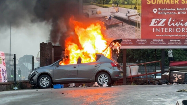 screengrab-taken-from-pa-video-of-a-vehicle-on-fire-near-clonavon-terrace-ballymena-as-people-take-part-in-a-protest-over-an-alleged-sexual-assault-in-the-co-antrim-town-police-used-water-cannon-to