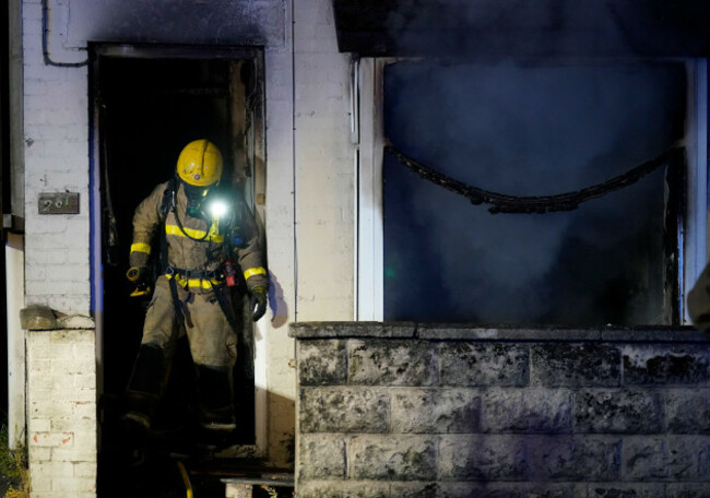 a-firefighter-exits-a-house-set-alight-during-a-second-night-of-violence-in-ballymena-as-people-take-part-in-a-protest-over-an-alleged-sexual-assault-in-the-co-antrim-town-police-used-water-cannon-t