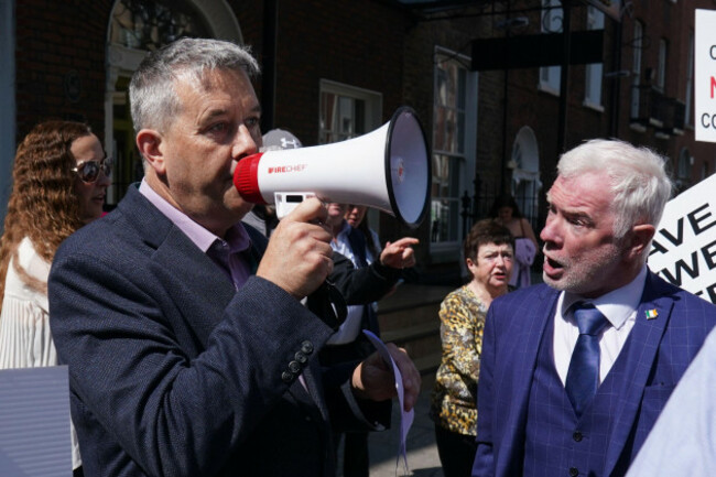 independent-td-for-dublin-mid-west-paul-gogarty-left-speaks-to-protesters-with-dublin-councillor-malachy-steenson-right-as-people-demonstrate-outside-leinster-house-in-dublin-over-government-plan