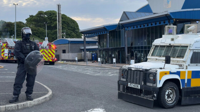 a-police-officer-at-the-scene-where-a-fire-has-broken-out-at-larne-leisure-centre-following-vandalism-at-the-facility-it-comes-after-two-nights-of-violence-and-public-disorder-in-the-town-of-ballymen