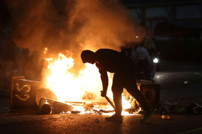 a-protester-stokes-a-barricade-fire-in-ballymena-northern-ireland-as-people-protest-over-an-alleged-sexual-assault-in-the-co-antrim-town-wednesday-june-11-2025-ap-photopeter-morrison