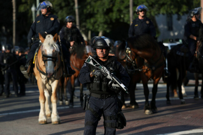 a-los-angeles-metro-police-officer-stands-guard-during-a-protest-on-wednesday-june-11-2025-in-los-angeles-ap-photoethan-swope