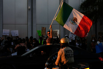 a-woman-waves-a-mexican-flag-during-protests-over-president-donald-trumps-stepped-up-enforcement-of-immigration-laws-wednesday-june-11-2025-in-las-vegas-ap-photojohn-locher