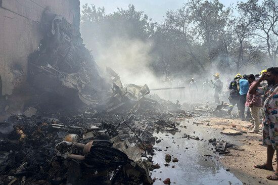 people-stand-around-debris-at-the-site-of-an-airplane-that-crashed-in-indias-northwestern-city-of-ahmedabad-in-gujarat-state-thursday-june12-2025-ap-photoajit-solanki