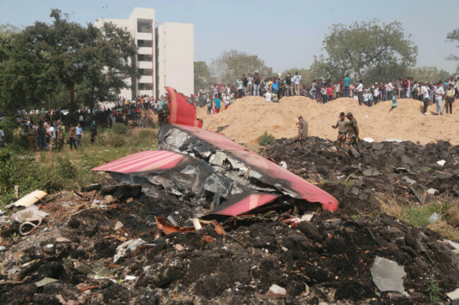 250612-ahmadabad-june-12-2025-xinhua-people-look-at-the-debris-of-an-air-india-plane-crashed-in-ahmedabad-of-indias-gujarat-state-june-12-2025-an-air-india-flight-to-london-with-242-pe
