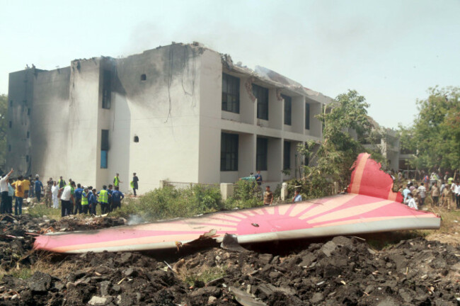 250612-ahmadabad-june-12-2025-xinhua-people-look-at-the-debris-of-an-air-india-plane-crashed-in-ahmedabad-of-indias-gujarat-state-june-12-2025-an-air-india-flight-to-london-with-242-pe